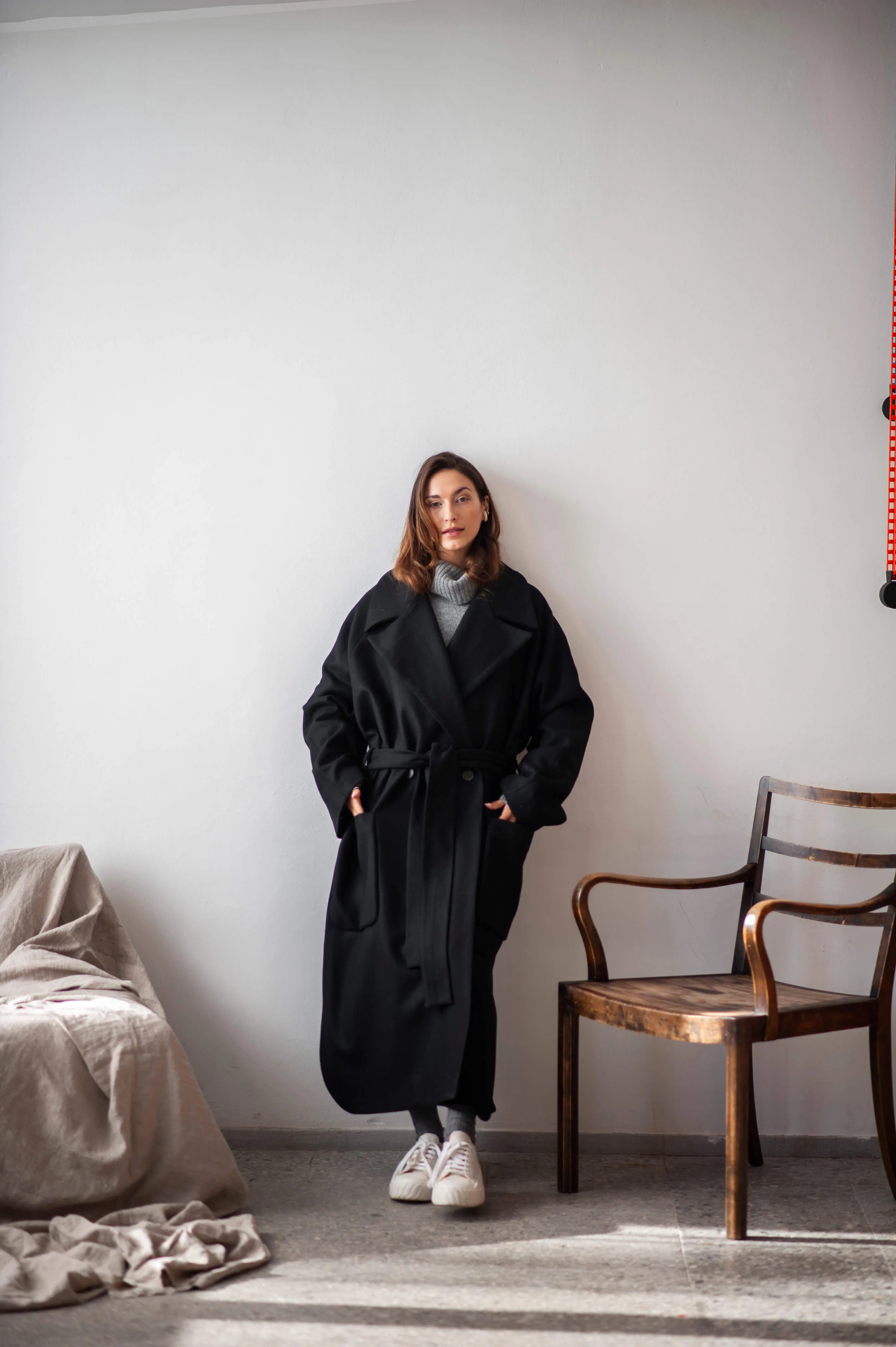 Women's oversized black wool coat with a belt