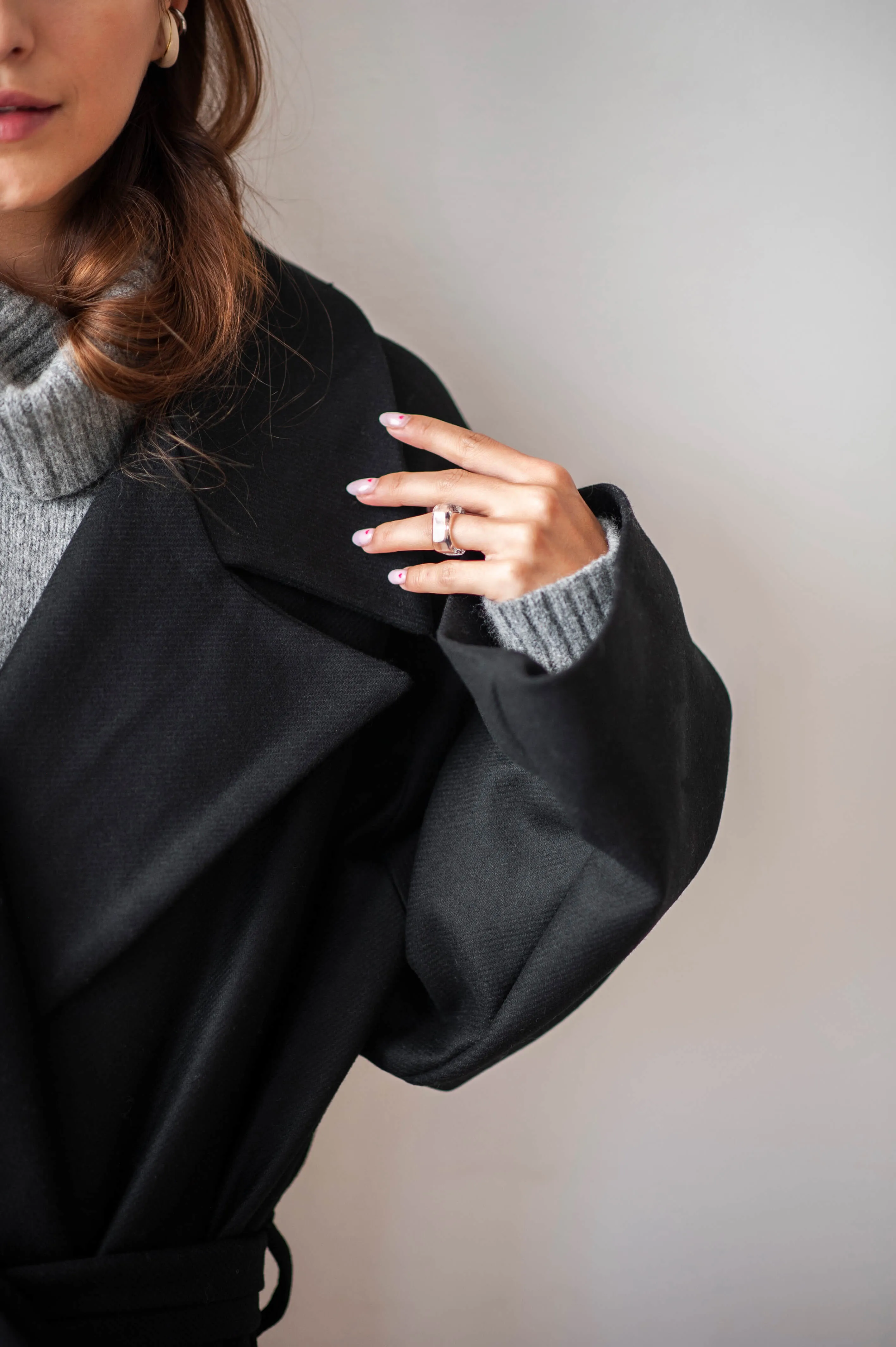 Women's oversized black wool coat with a belt