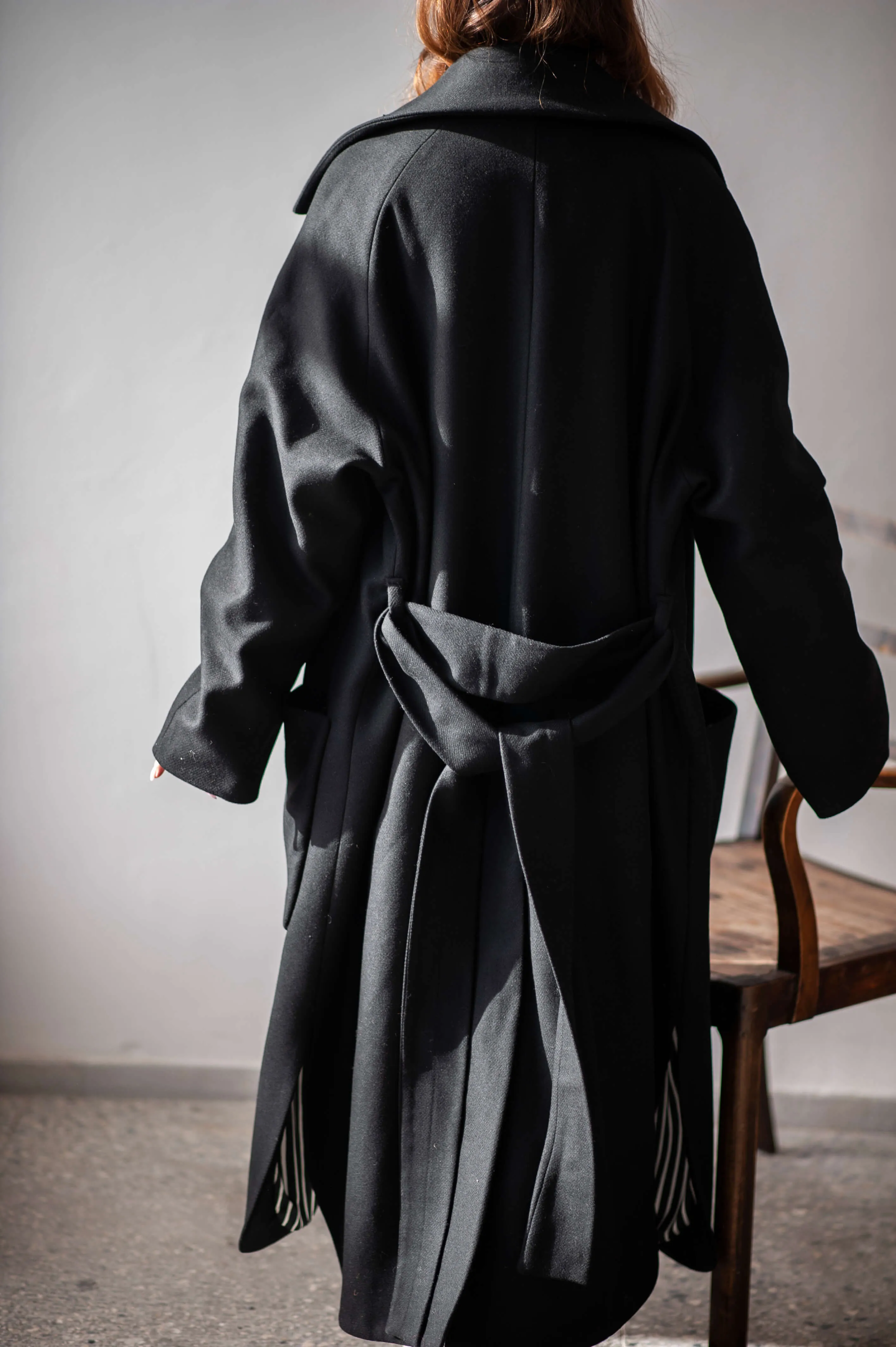 Women's oversized black wool coat with a belt